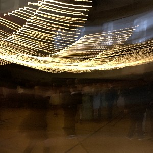 A blurred photo of lights hanging at the dance.