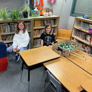 Students playing a cardboard game.