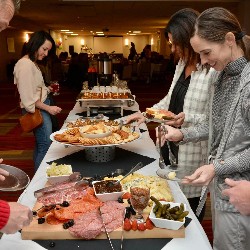 Parents filling up their plates at the buffet