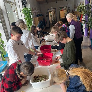 Students at School in the Woods working on tile projects during art class.