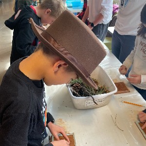 Student at School in the Woods working on tile projects during art class.