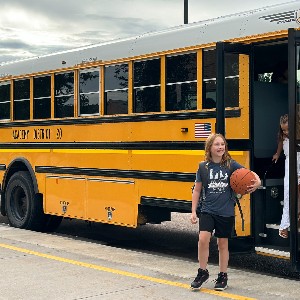 Students walking off the bus.