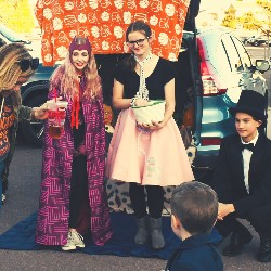 Students dressed in costume and handing out candy