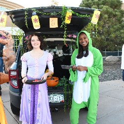 Students posing for a photo at Trunk or Treat 2022