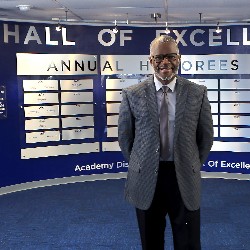 MSgt. Anthony Rush poses in front of Hall of Excellence