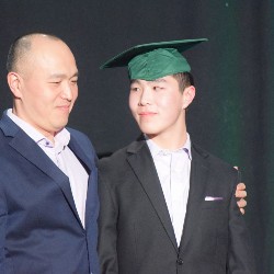 Graduate looking his dad in the eye