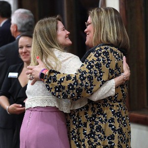 ASD20 Board of Education Treasurer Heather Cloninger hugs and smiles a retiree