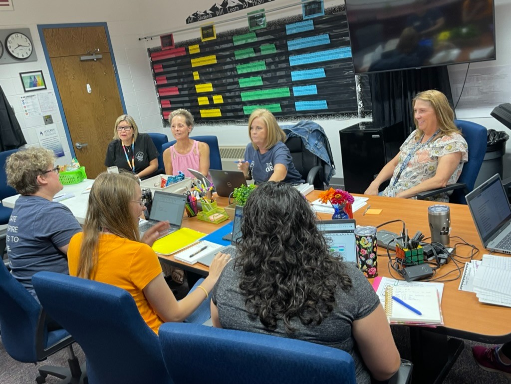 A group of teachers planning lessons during a PLC day.