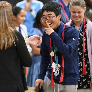 Student laughing while receiving medal