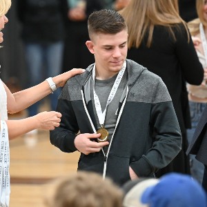 Student with medal around his neck