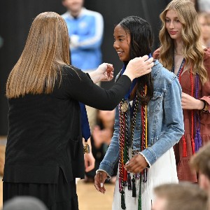 Girl wearing Graduation cords and medals