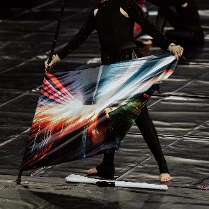 Color guard member performs with flag.