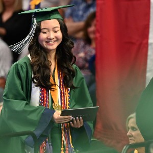 Student smiling after receiving her diploma
