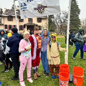 Group smiling underneath a sign that says, "Plunge Plaza"