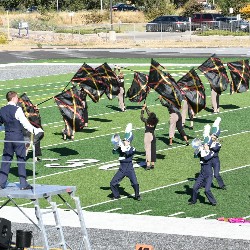 Color Guard waiving black and red flags during a performance at the Harrison Marching Band Festival