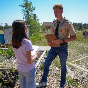 A student council member speaks to Eagle Scout Andrew Vider