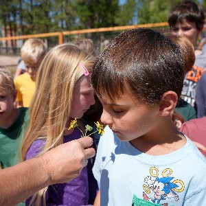 A student smells a flower