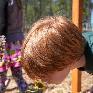 Student smells flower