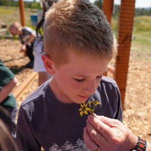 Student smells flower