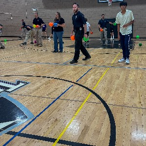 students and Colorado Springs police officers play dodgeball