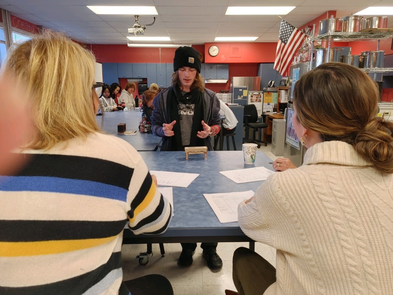 Interior design student, Peter Patchin, presents his piece to the community judges.