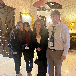 A group of students posing together in the Broadmoor lobby