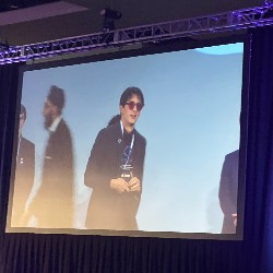 Josh, in sunglasses, poses onstage with his trophy
