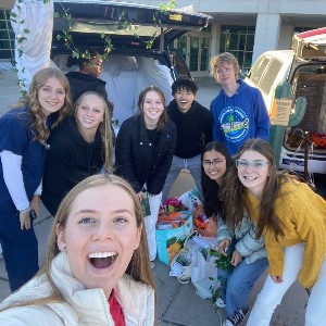 Student selfie in front of car