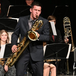 Student playing baritone saxophone