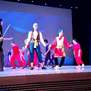 Students performing on stage.