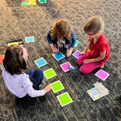 Students programming Indi robots