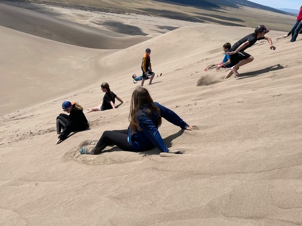 Photo from Rodney Pierson of students playing on the dunes 