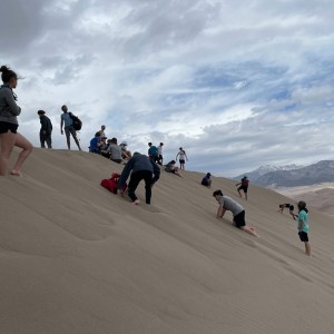 Photo from Rodney Pierson of students playing on the dunes 