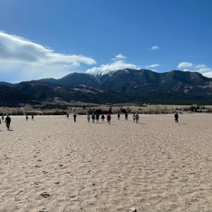 Photo from Rodney Pierson of students walking away from the dunes towards the mountains