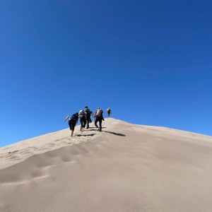 Students climbing the sand dunes