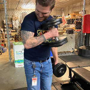 Teacher, Mr. Burney, performing arm curls