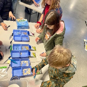 School in the Woods students experimenting with various vegetable seeds during a lesson.