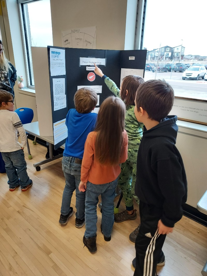 Students looking at science fair project