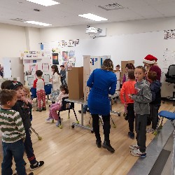 Students and staff looking at science fair project