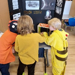 Students looking at science fair project