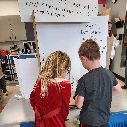 Students looking at science fair project