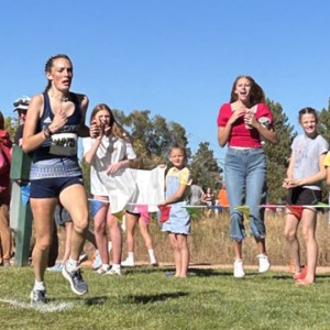 Girl running with excited fan on sidelines