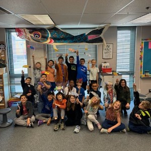 Students holding decorated fish.