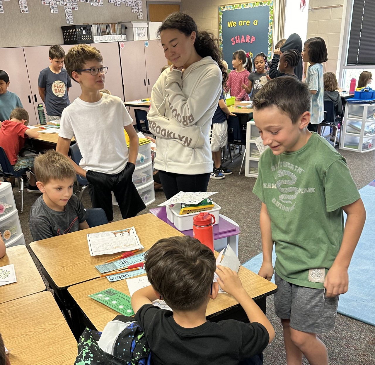 5th grade students making a craft with 2nd grade students