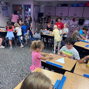 4th grade students making a craft with 1st grade students