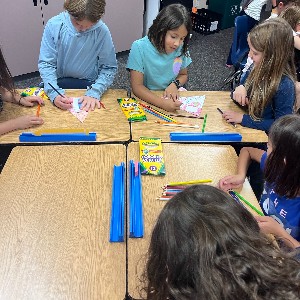 4th grade students making a craft with 1st grade students