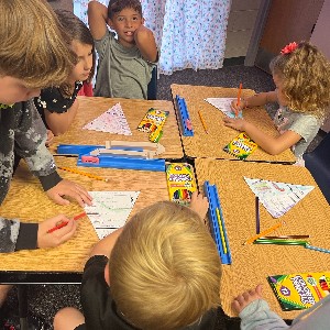 4th grade students making a craft with 1st grade students