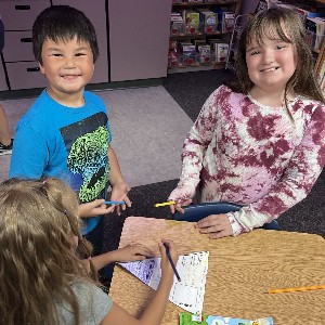 4th grade students making a craft with 1st grade students