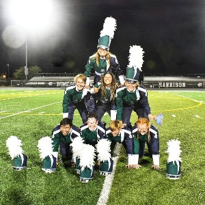 Band students in tripod on field