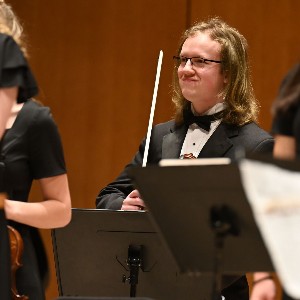 Student smiles at the end of the concert